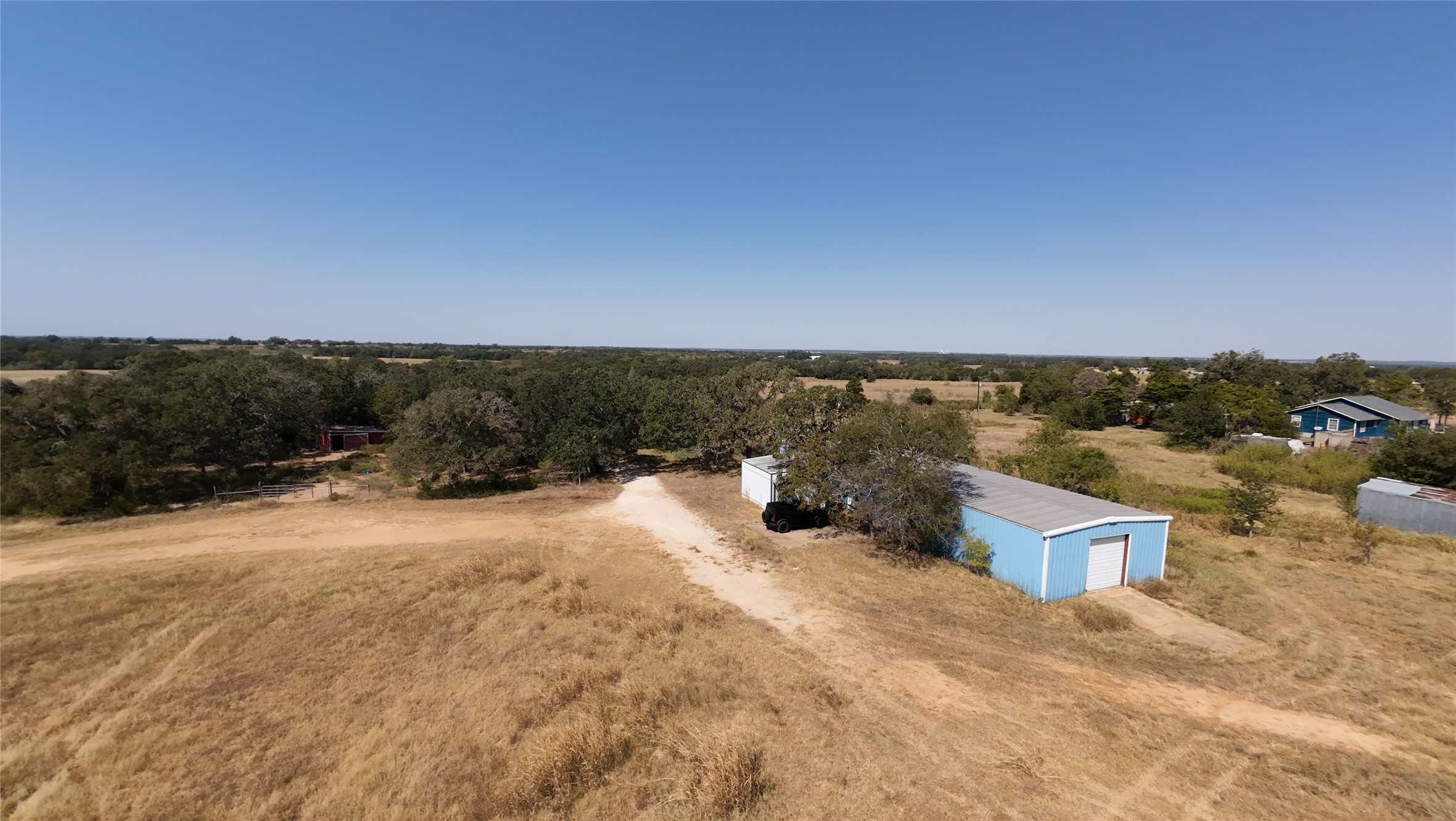 741 Knobbs Road McDade, TX 78650 - Photo 35 of 38 A tranquil, sprawling rural estate offers abundant space and distant views under an expansive sky.