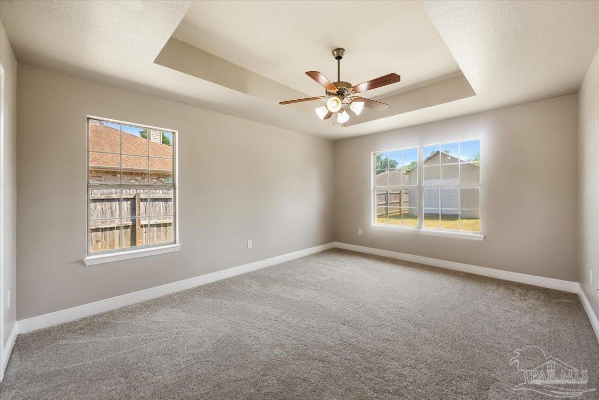 4015 Berry Circle Pace, FL 32571 - Photo 30 of 48 an empty room with windows and ceiling fan