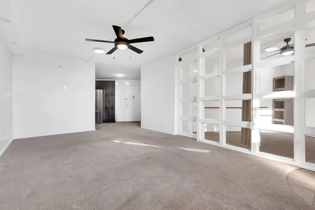 a living room with furniture potted plant and a chandelier