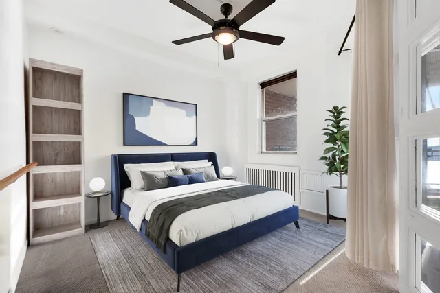 a view of a livingroom with a ceiling fan and window