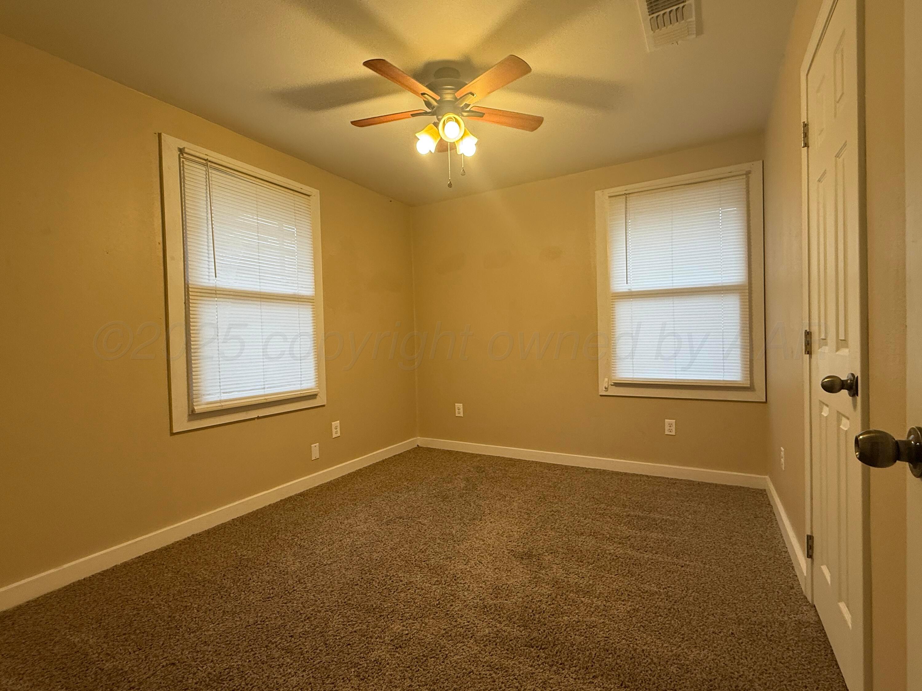 701 East 3rd Street Dumas, TX 79029 - Photo 11 of 14 a view of an empty room with a window