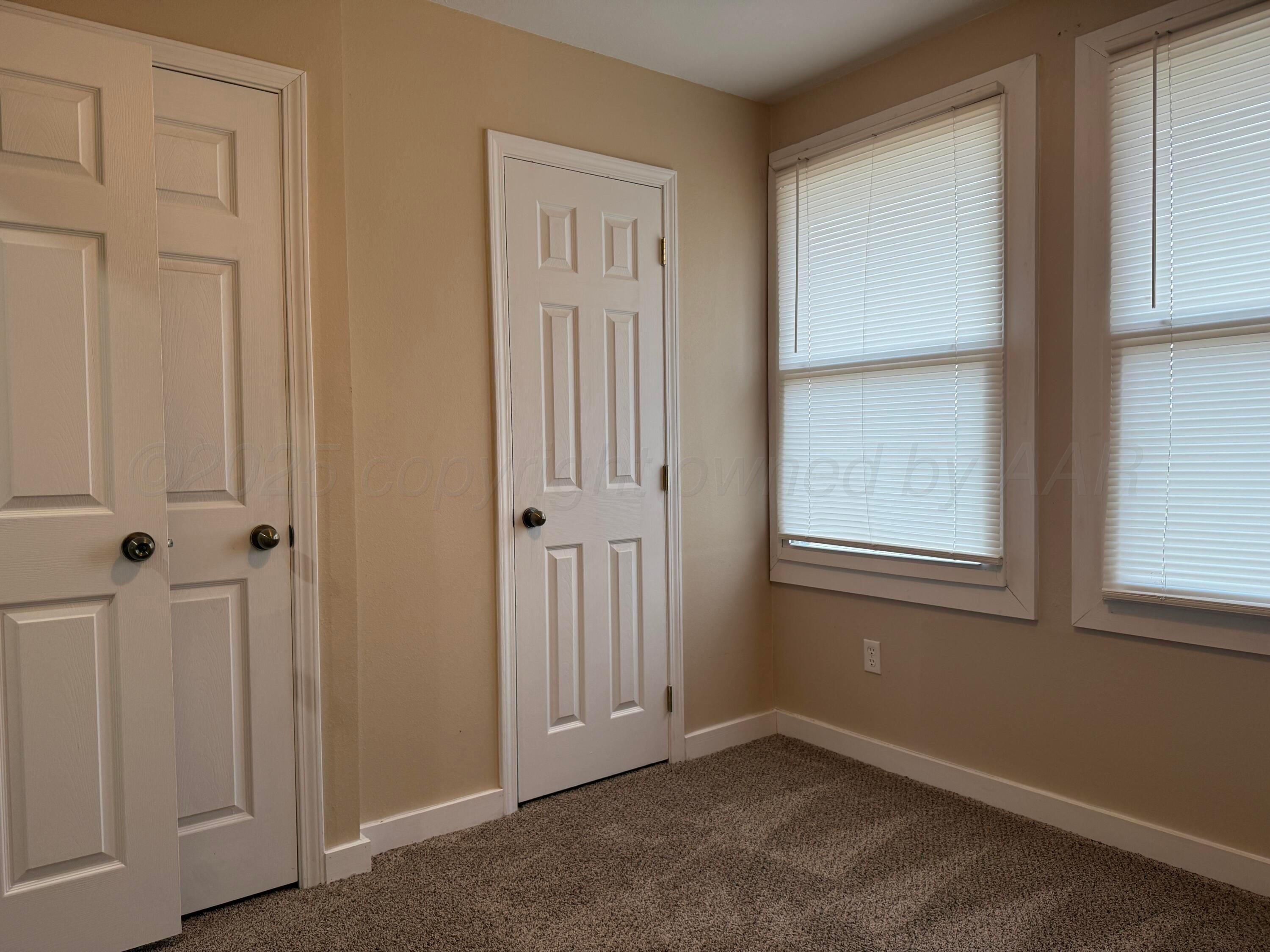 701 East 3rd Street Dumas, TX 79029 - Photo 12 of 14 an empty room with windows