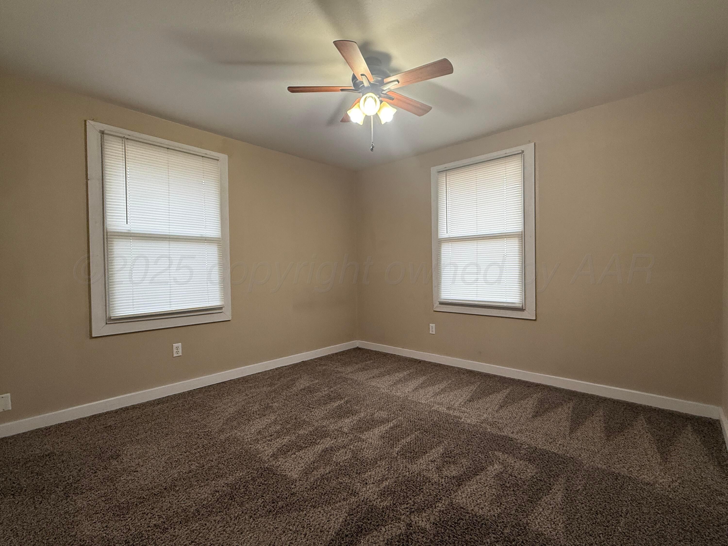 701 East 3rd Street Dumas, TX 79029 - Photo 6 of 14 a view of an empty room with a window