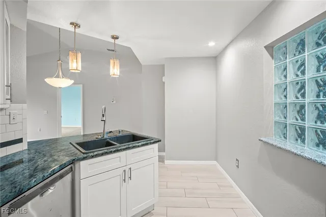 a kitchen with a sink and cabinets