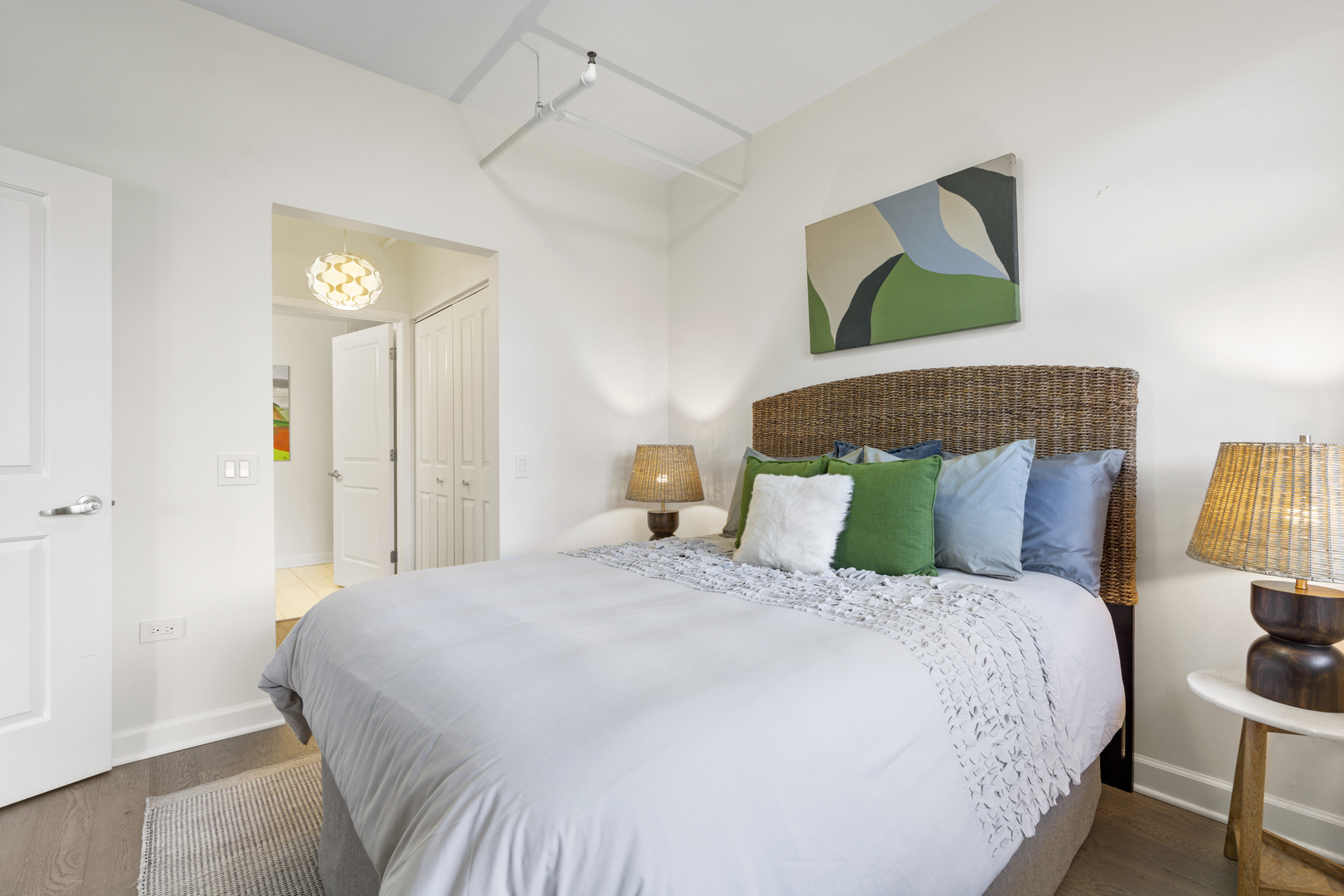 437 West Division Street, Unit 310 Chicago, IL 60610 - Photo 14 of 23 a large bed sitting in a bedroom and a lamp