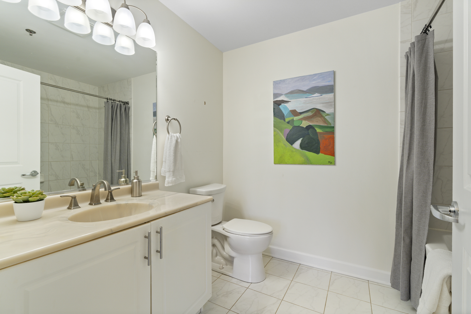 437 West Division Street, Unit 310 Chicago, IL 60610 - Photo 16 of 23 a bathroom with a sink a toilet and a mirror