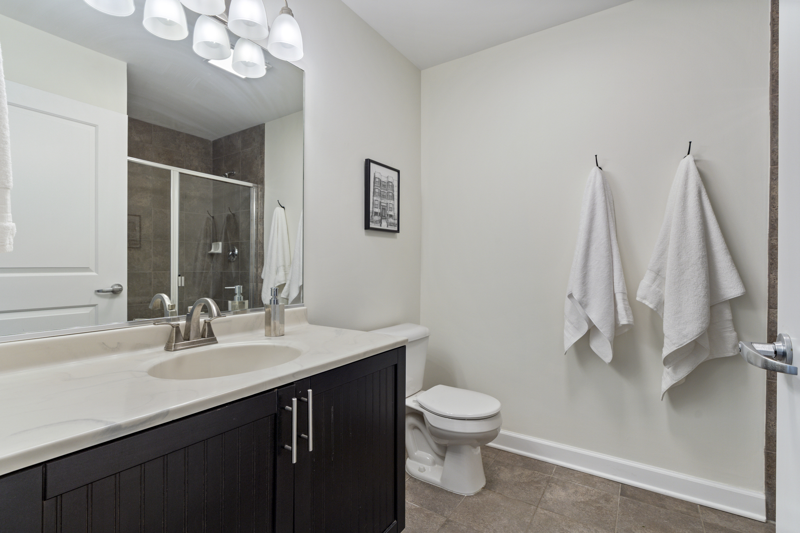 437 West Division Street, Unit 310 Chicago, IL 60610 - Photo 19 of 23 a bathroom with a sink a toilet and a mirror