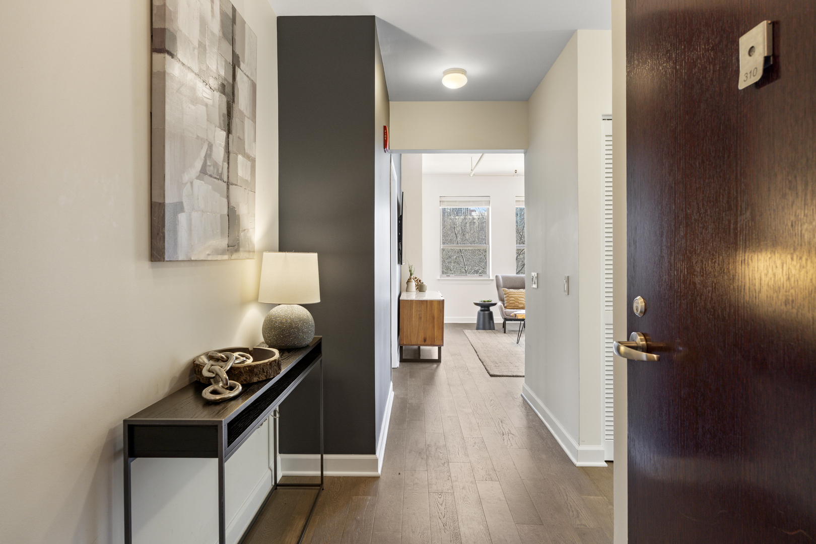 437 West Division Street, Unit 310 Chicago, IL 60610 - Photo 2 of 23 a hallway with couches and wooden floor