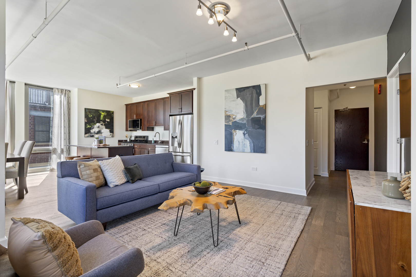 437 West Division Street, Unit 310 Chicago, IL 60610 - Photo 7 of 23 a living room with furniture and a dining table