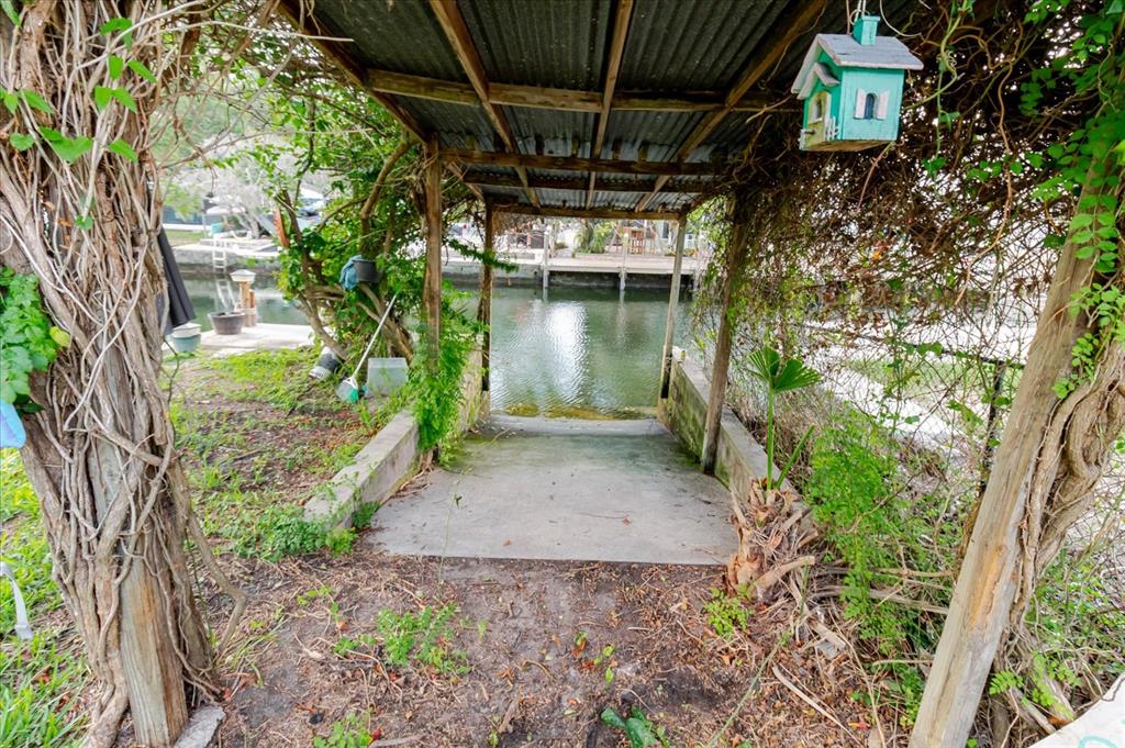 5323 Circle Drive Weeki Wachee, FL 34607 - Photo 70 of 77 a backyard of a house with a garden and outdoor seating