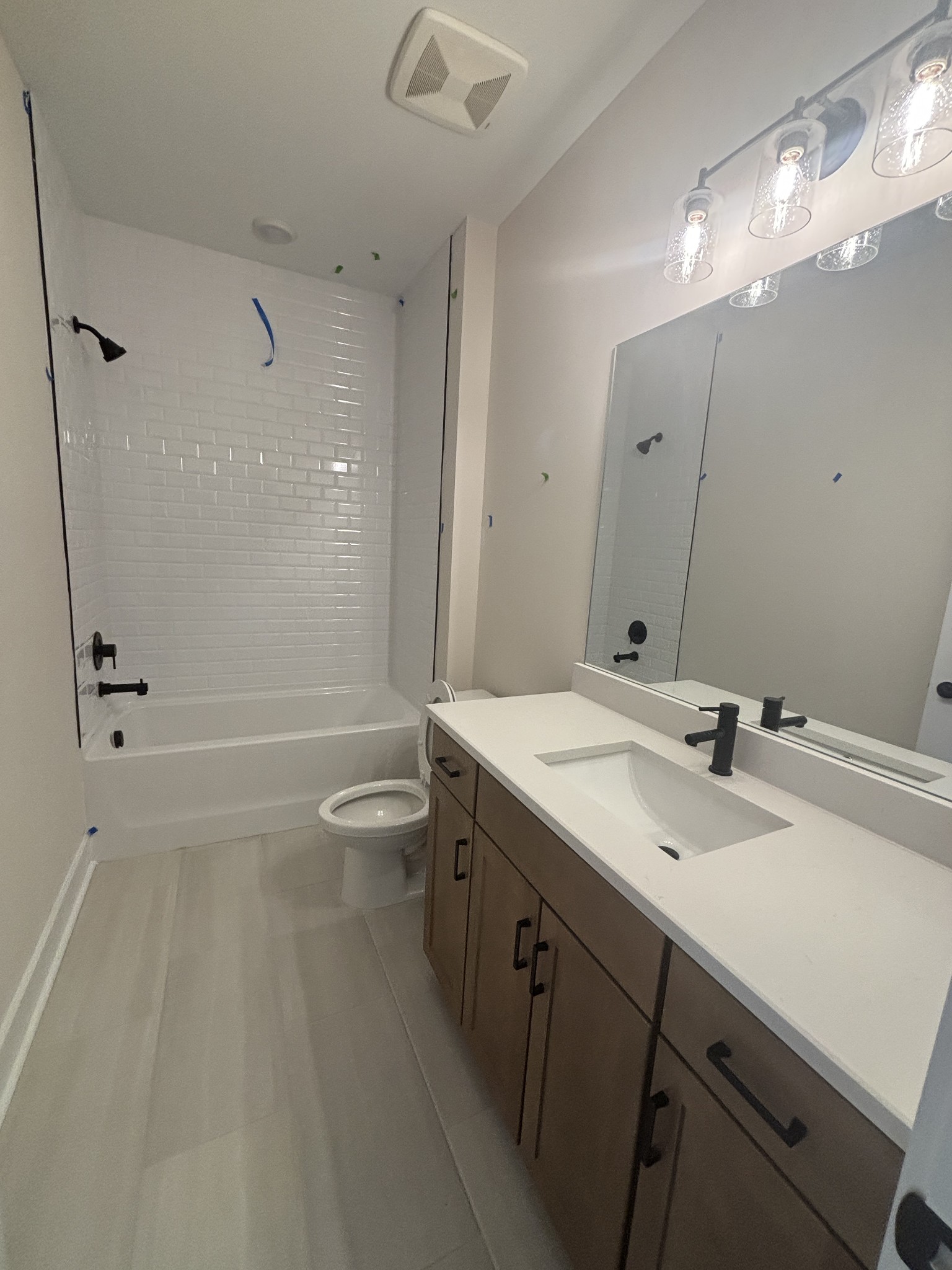 532 Scarlet Oak Road Lebanon, TN 37090 - Photo 31 of 40 a bathroom with a granite countertop sink a toilet a mirror and shower