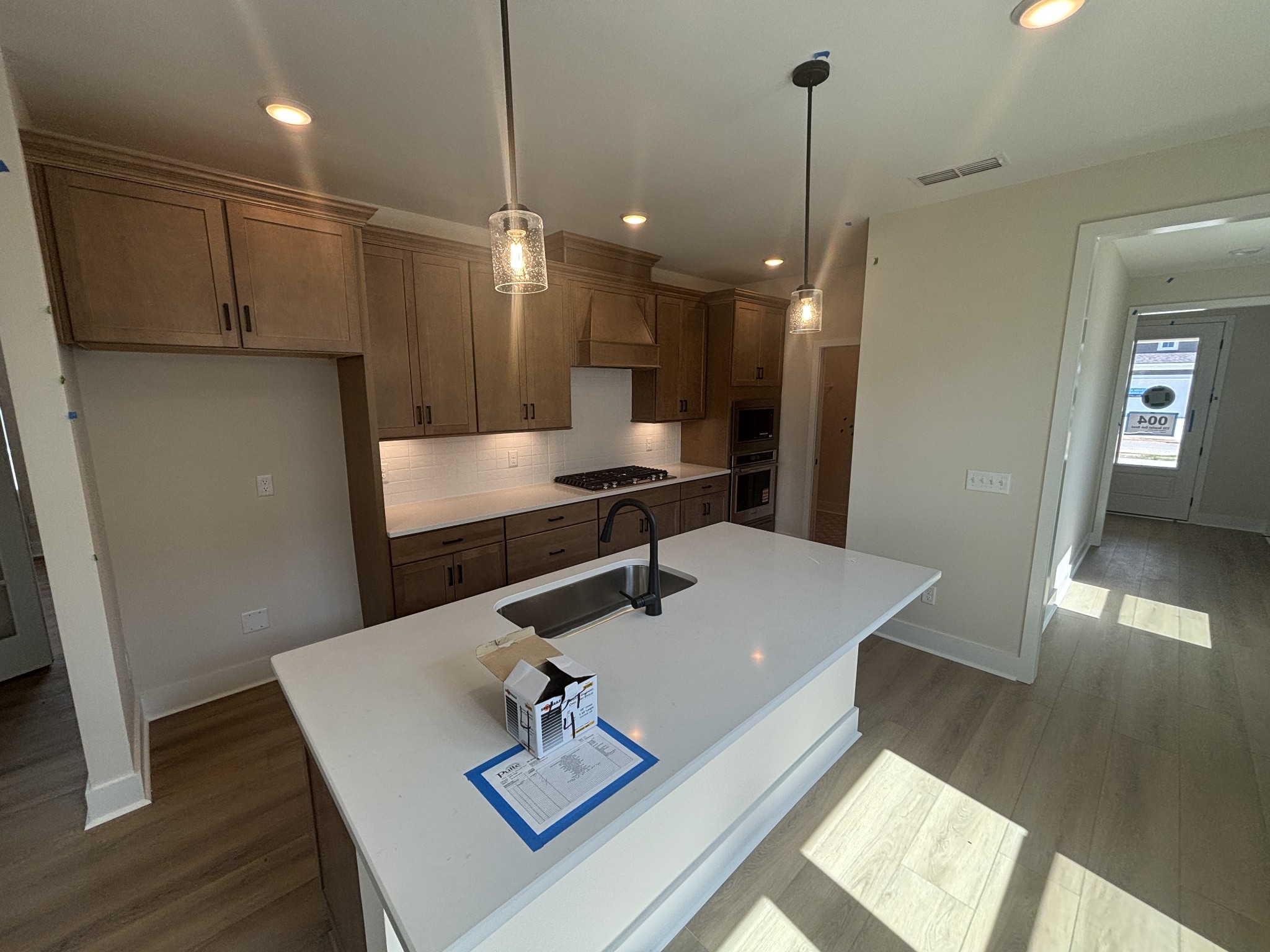 532 Scarlet Oak Road Lebanon, TN 37090 - Photo 36 of 40 a kitchen with a sink a refrigerator and wooden floor