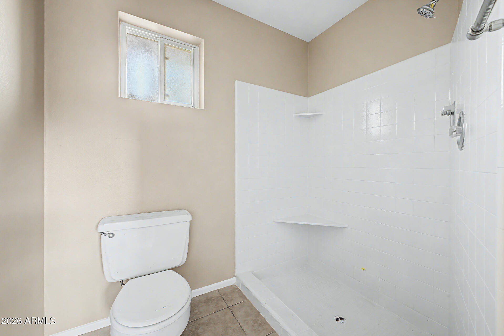 4007 West Mountain View Road Phoenix, AZ 85051 - Photo 21 of 31 a white toilet sitting next to a shower