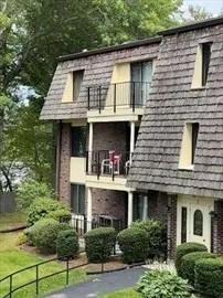a front view of a house with plants
