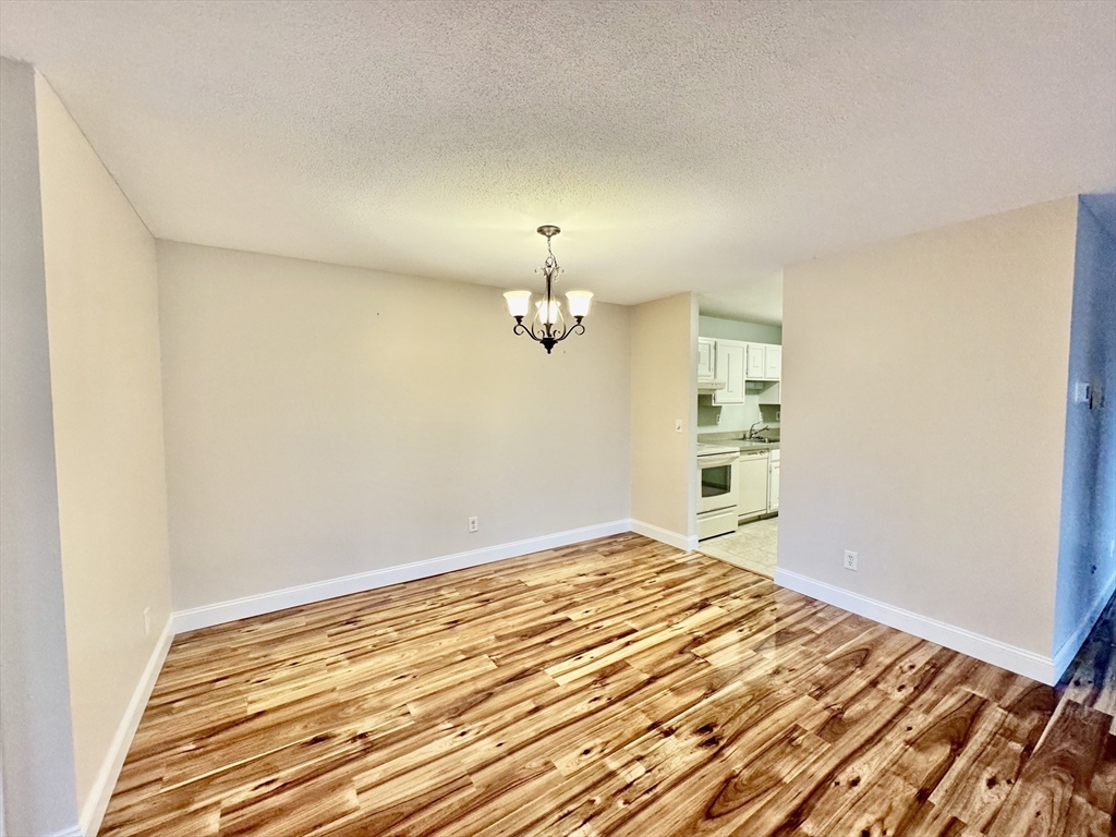 4700 North Main Street, Unit 3E Fall River, MA 02720 - Photo 3 of 9 a view of empty room with wooden floor