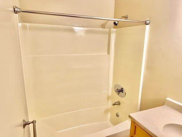 a bathroom with a shower and a bath tub