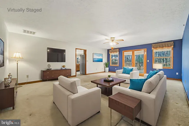 an empty room with fan and windows