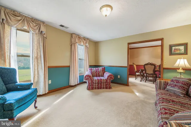 a view of a dining room with furniture and a chandelier