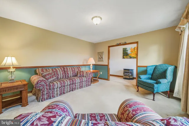 a dining room with furniture a chandelier and window