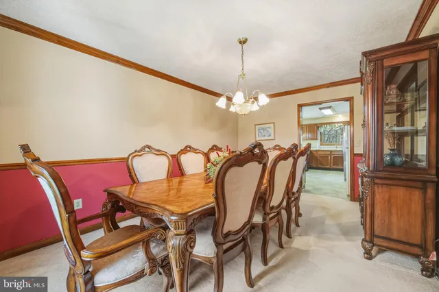 a spacious bedroom with a bed and a chandelier