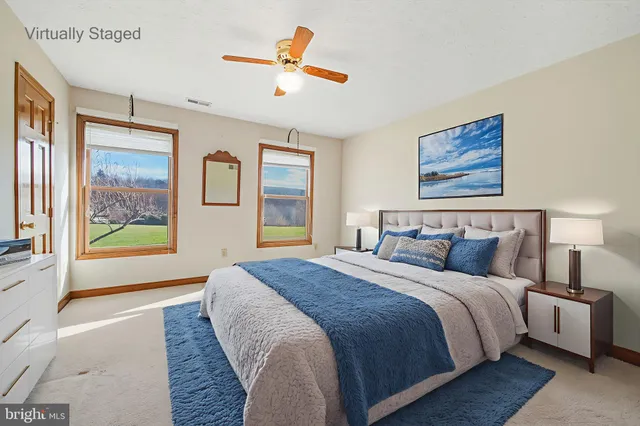 an empty room with closet and ceiling fan