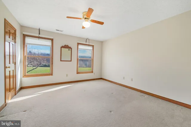 a bedroom with a bed couch and window