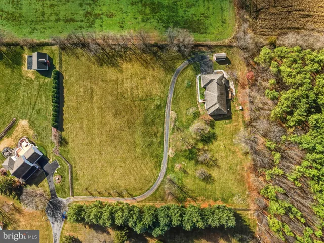 a view of a chair and table in backyard of the house