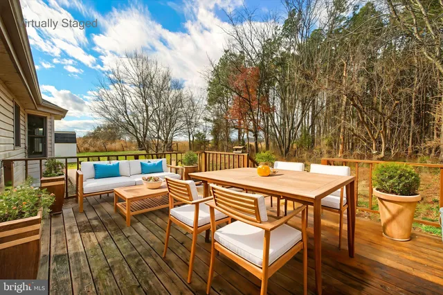 a view of an house with backyard space and balcony