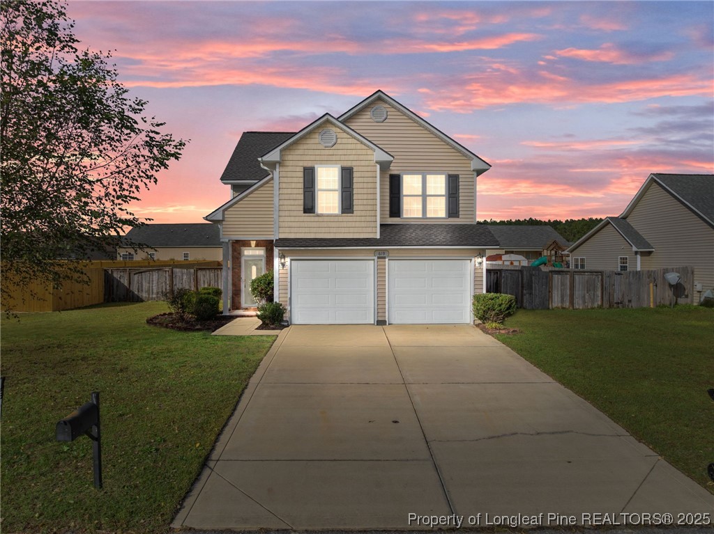 a front view of a house with a yard and garage