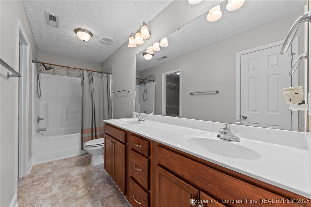 619 Cape Fear Road Raeford, NC 28376 - Photo 16 of 23 a bathroom with a double vanity sink mirror and shower