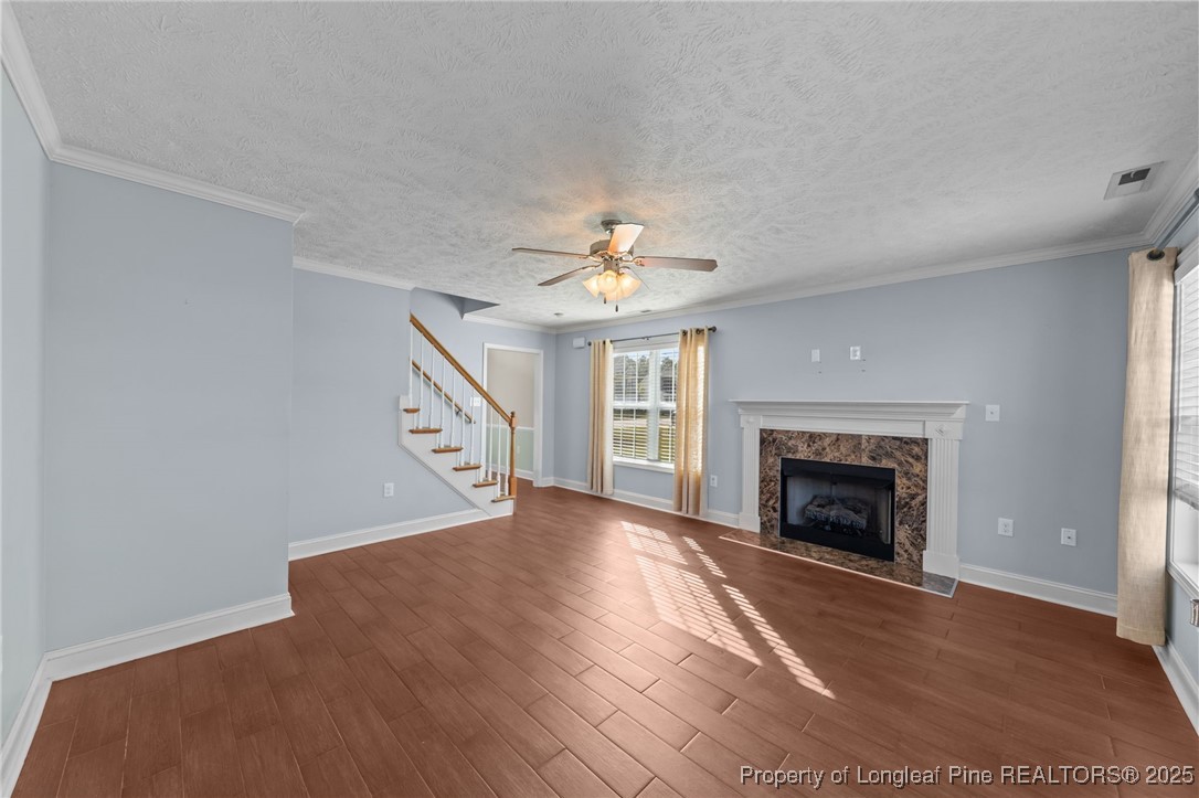 619 Cape Fear Road Raeford, NC 28376 - Photo 5 of 23 a view of an empty room with wooden floor fireplace and a window