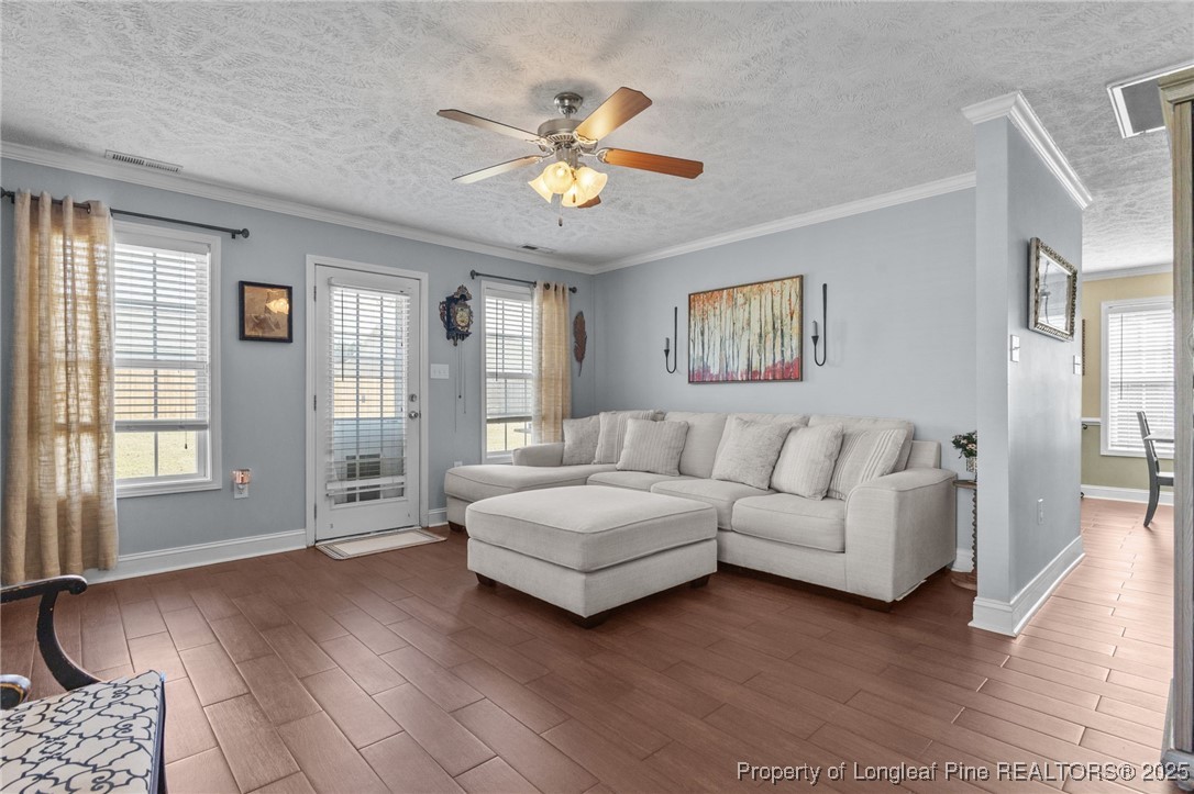 619 Cape Fear Road Raeford, NC 28376 - Photo 7 of 23 a living room with couches and a chandelier with wooden floor