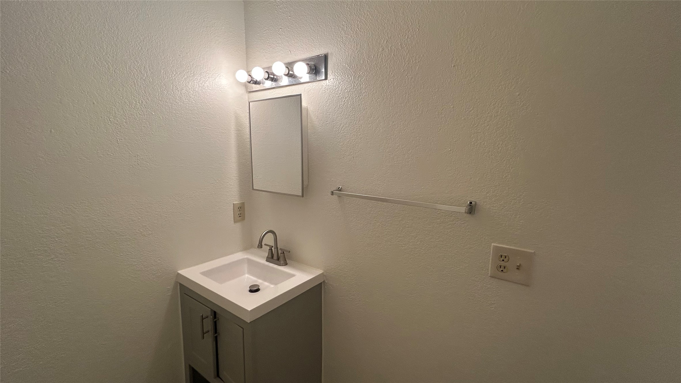 23393 Nameless Road, Unit 142 Leander, TX 78641 - Photo 13 of 15 A well-maintained powder room, featuring a sleek vanity with an integrated sink and modern fixtures.