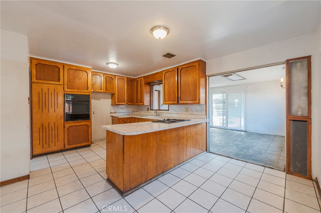 22428 Neptune Avenue Carson, CA 90745 - Photo 36 of 36 a kitchen with stainless steel appliances granite countertop a refrigerator and a sink