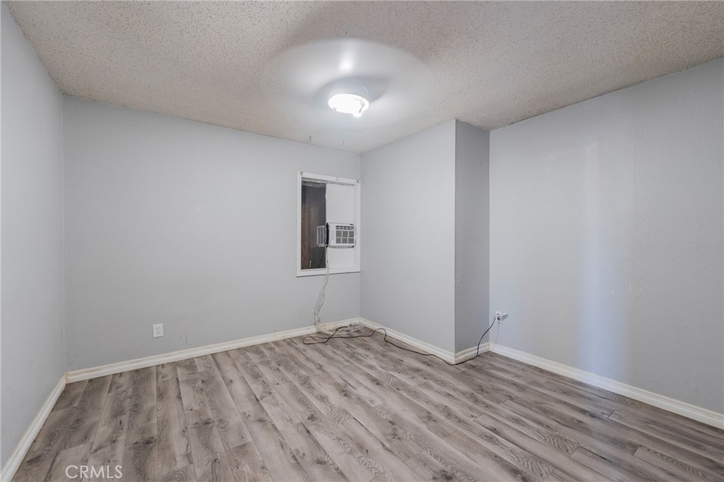 22428 Neptune Avenue Carson, CA 90745 - Photo 10 of 36 a view of empty room with wooden floor