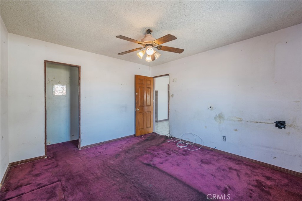 22428 Neptune Avenue Carson, CA 90745 - Photo 11 of 36 a view of a big room with closet and chandelier fan