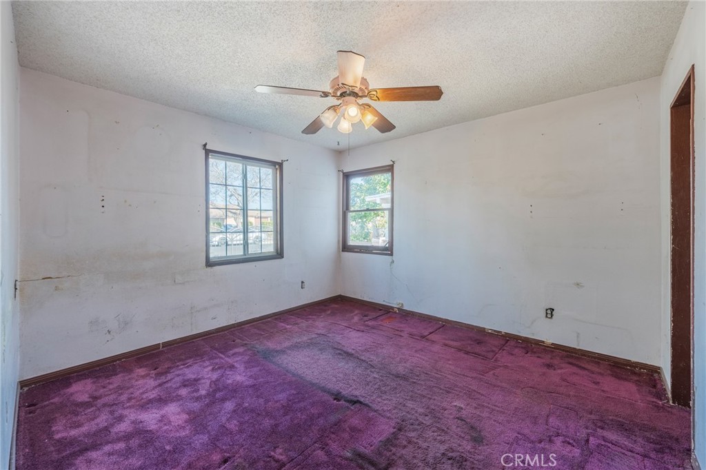 22428 Neptune Avenue Carson, CA 90745 - Photo 12 of 36 an empty room with windows and fan