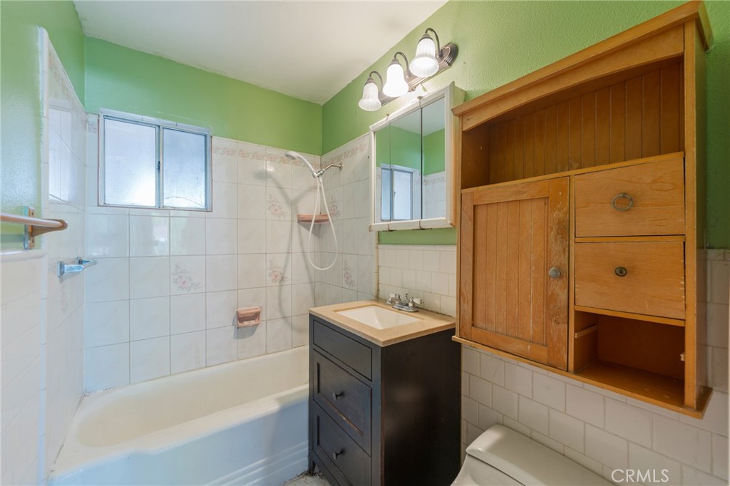 22428 Neptune Avenue Carson, CA 90745 - Photo 15 of 36 a bathroom with a tub and a sink