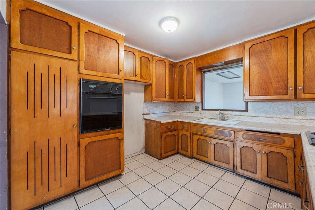 22428 Neptune Avenue Carson, CA 90745 - Photo 16 of 36 a kitchen with stainless steel appliances granite countertop cabinets and a sink