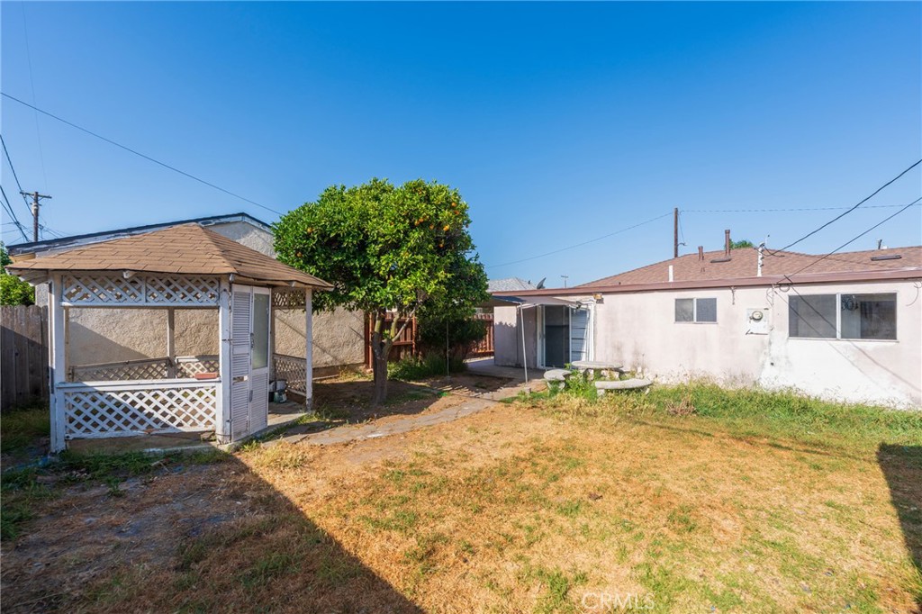 22428 Neptune Avenue Carson, CA 90745 - Photo 19 of 36 a front view of a house with a yard and garage