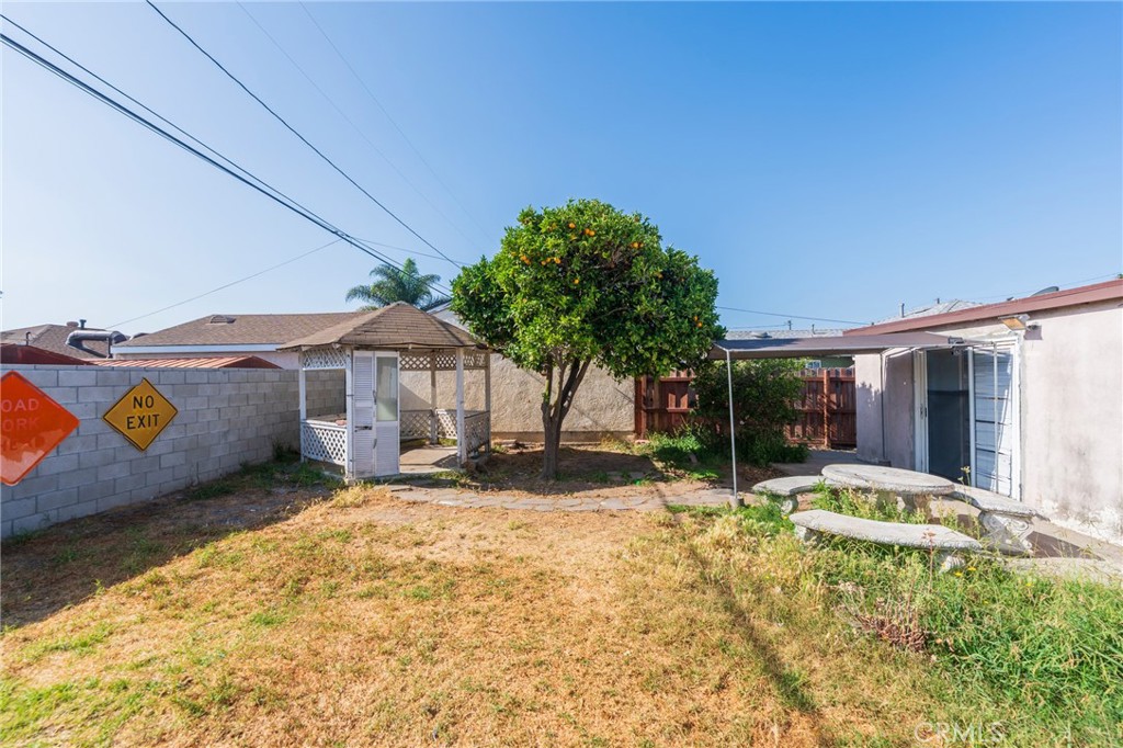 22428 Neptune Avenue Carson, CA 90745 - Photo 20 of 36 a backyard of a house with barbeque oven and outdoor seating