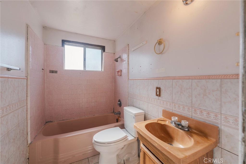 22428 Neptune Avenue Carson, CA 90745 - Photo 25 of 36 a bathroom with a sink a toilet and shower