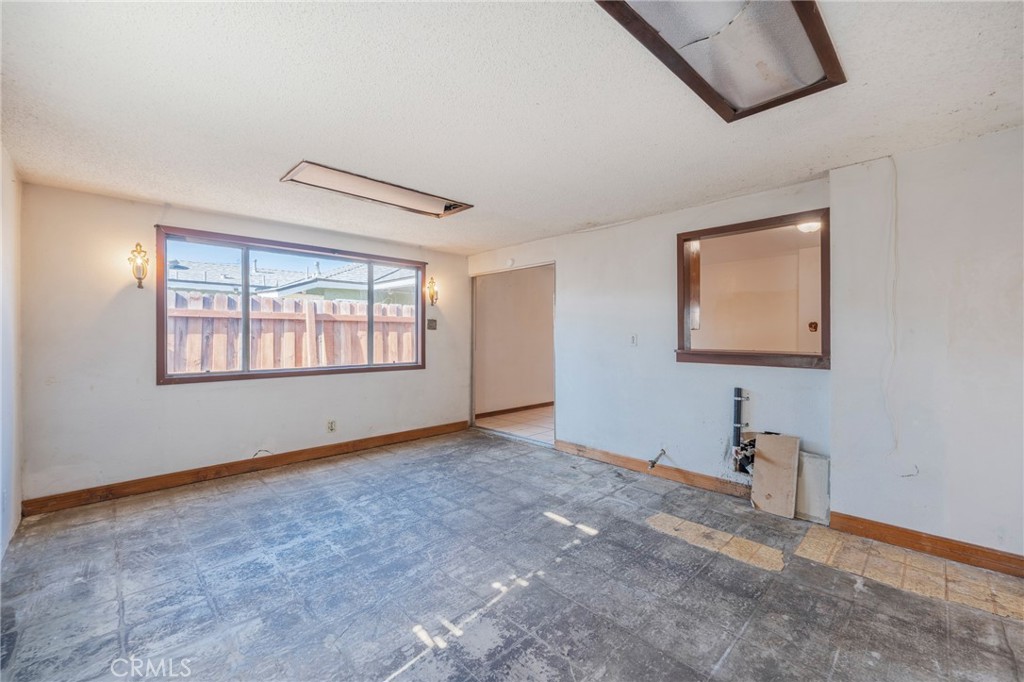 22428 Neptune Avenue Carson, CA 90745 - Photo 26 of 36 an empty room with windows and cabinet