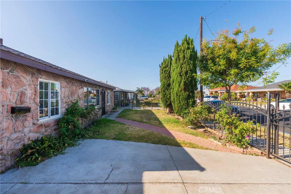 22428 Neptune Avenue Carson, CA 90745 - Photo 3 of 36 a view of a house with a yard and potted plants