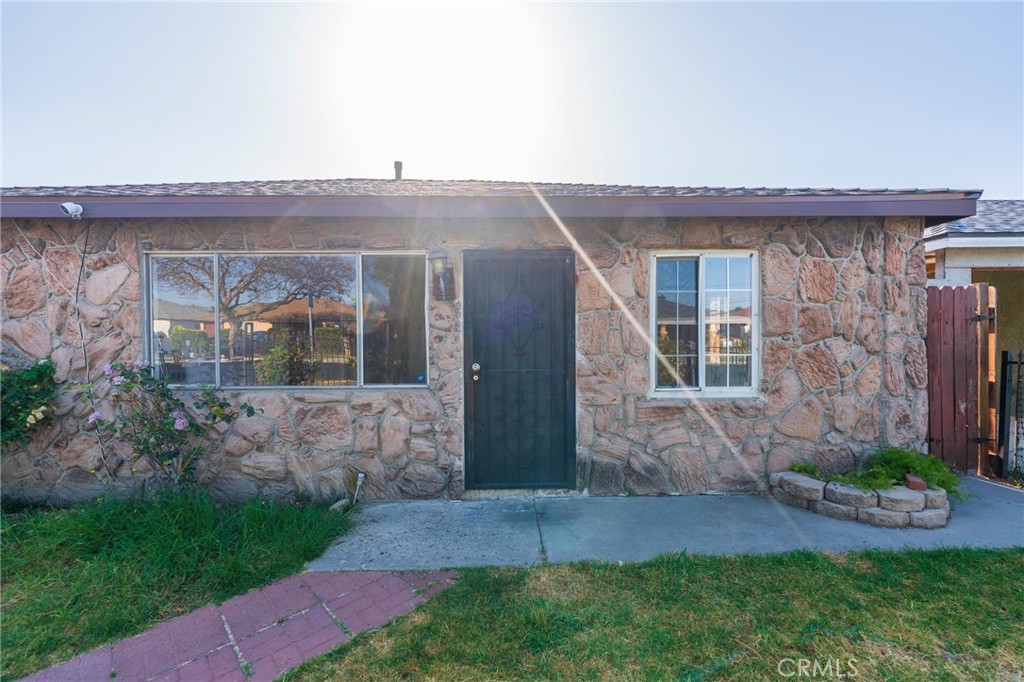 22428 Neptune Avenue Carson, CA 90745 - Photo 4 of 36 a front view of a house with a garden