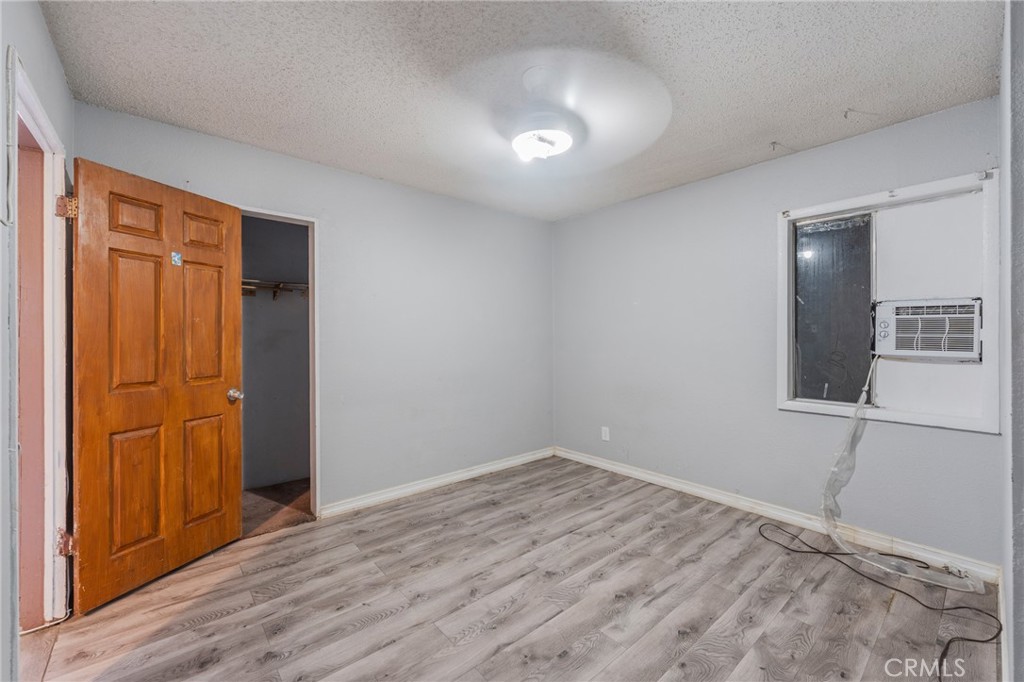22428 Neptune Avenue Carson, CA 90745 - Photo 8 of 36 a view of empty room with wooden floor and fan