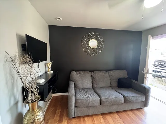 a living room with furniture and a flat screen tv