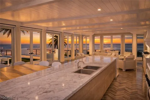 a front view of multi story residential apartment building with yard and bench