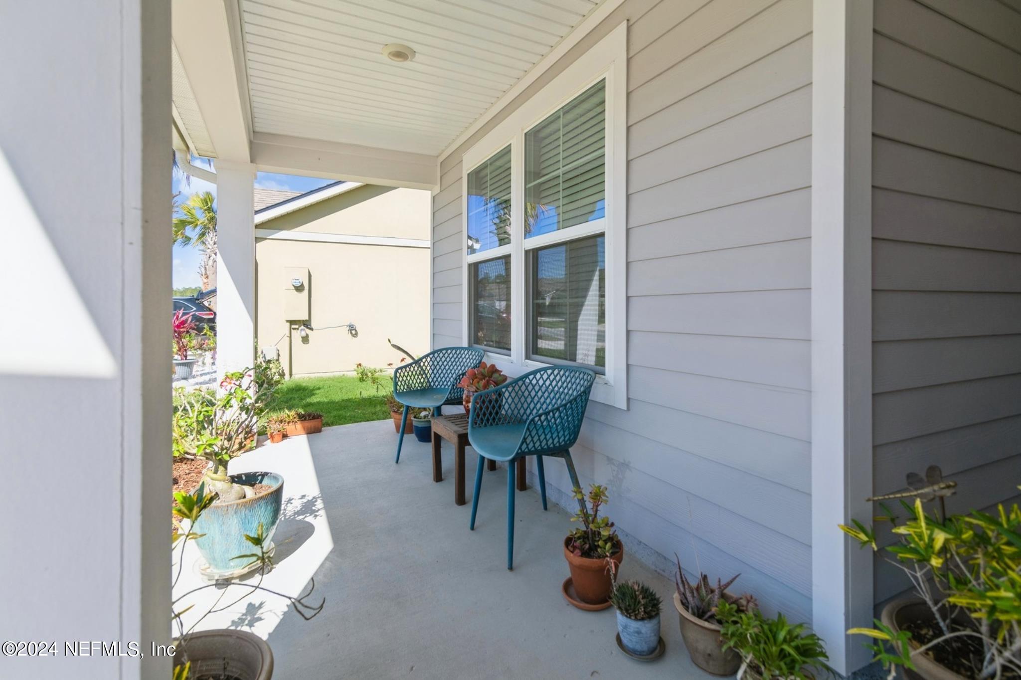 97 Spotted Owl Lane St. Augustine, FL 32095 - Photo 11 of 38 a backyard of a house with table and chairs potted plants