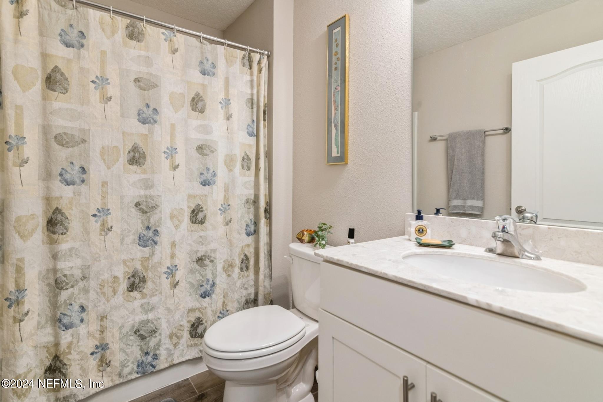 97 Spotted Owl Lane St. Augustine, FL 32095 - Photo 13 of 38 a bathroom with a granite countertop sink a toilet and a mirror